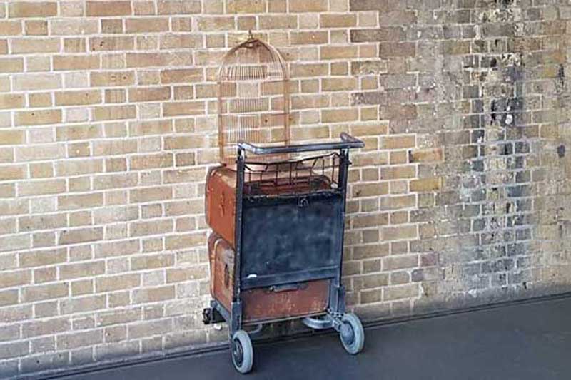 A trolley embedded in the wall of Platform nine-and-three-quarters at King's Cross Station.