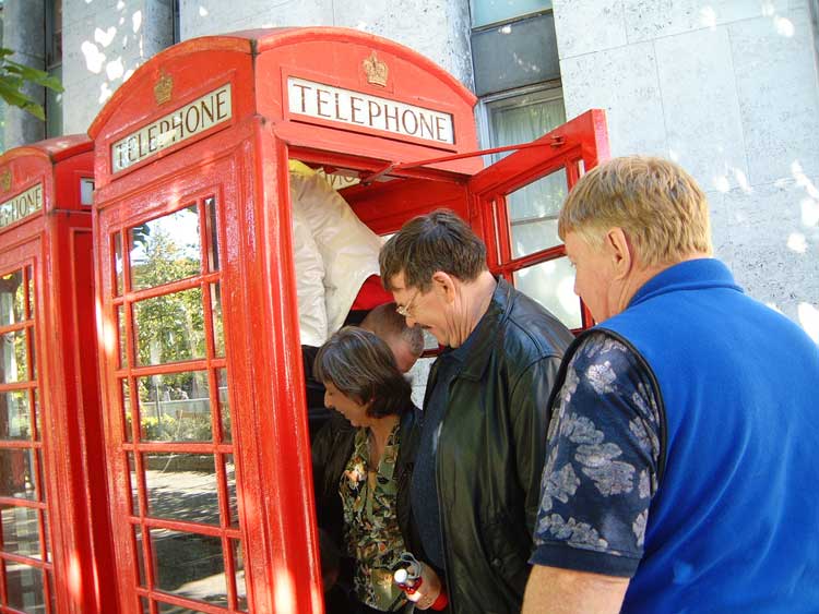 People entering a phone box to pose for descending into the Ministry of Magic.
